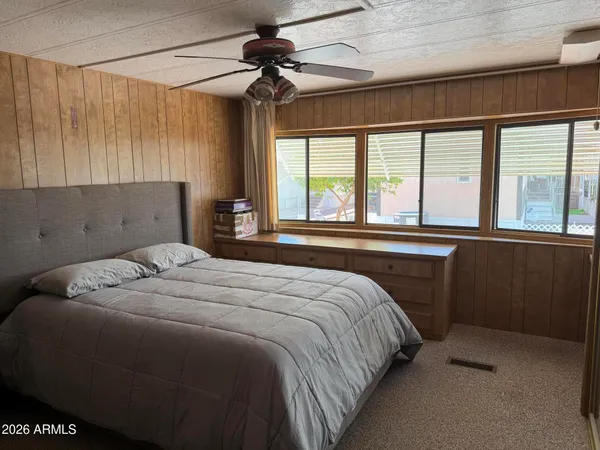 a bedroom with a large bed and a large window