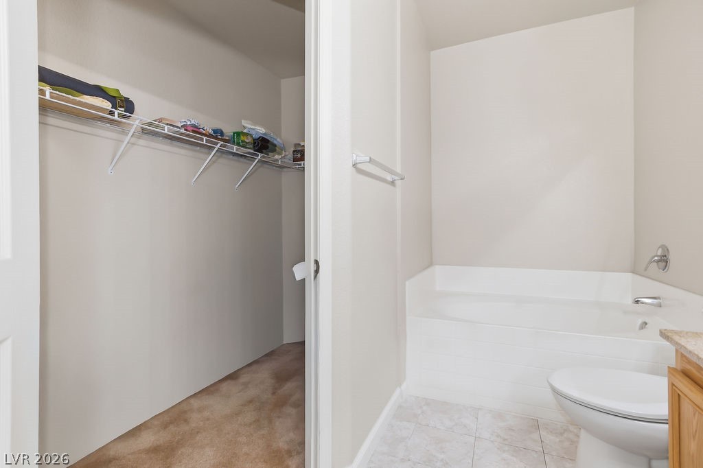 10550 West Alexander Road, Unit 2133 Las Vegas, NV 89129 - Photo 33 of 42 This primary bathroom features a corner tub and adjacent walk-in closet for ultimate convenience.