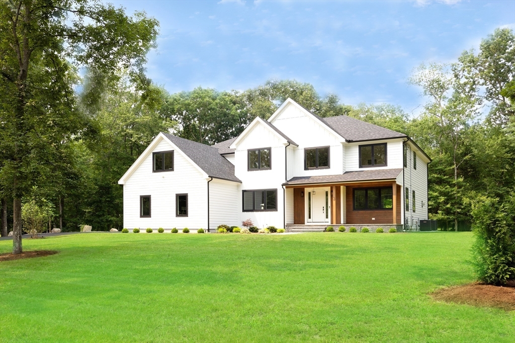 a front view of a house with a garden and porch