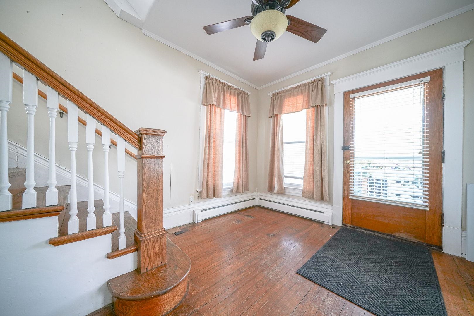 408 South 5th Street Oregon, IL 61061 - Photo 13 of 43 a view of an empty room with wooden floor and a window