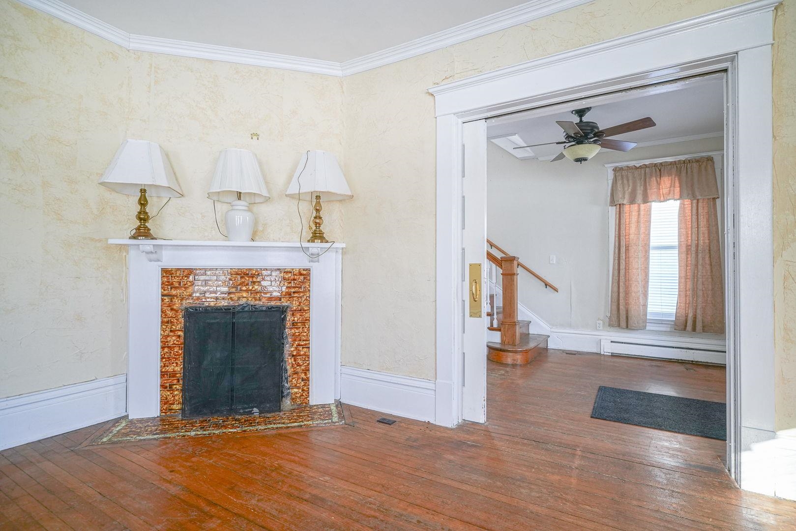 408 South 5th Street Oregon, IL 61061 - Photo 15 of 43 a view of an empty room with wooden floor fireplace and a window