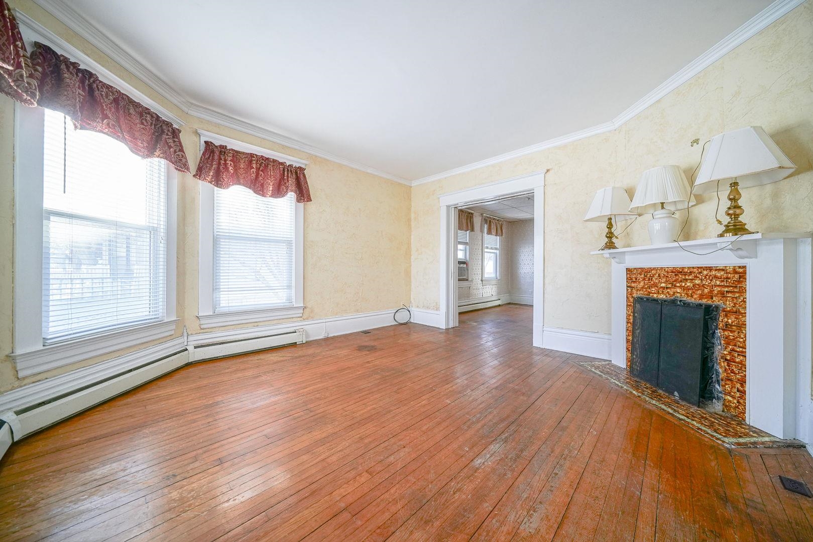 408 South 5th Street Oregon, IL 61061 - Photo 42 of 43 a view of an empty room with wooden floor fireplace and a window
