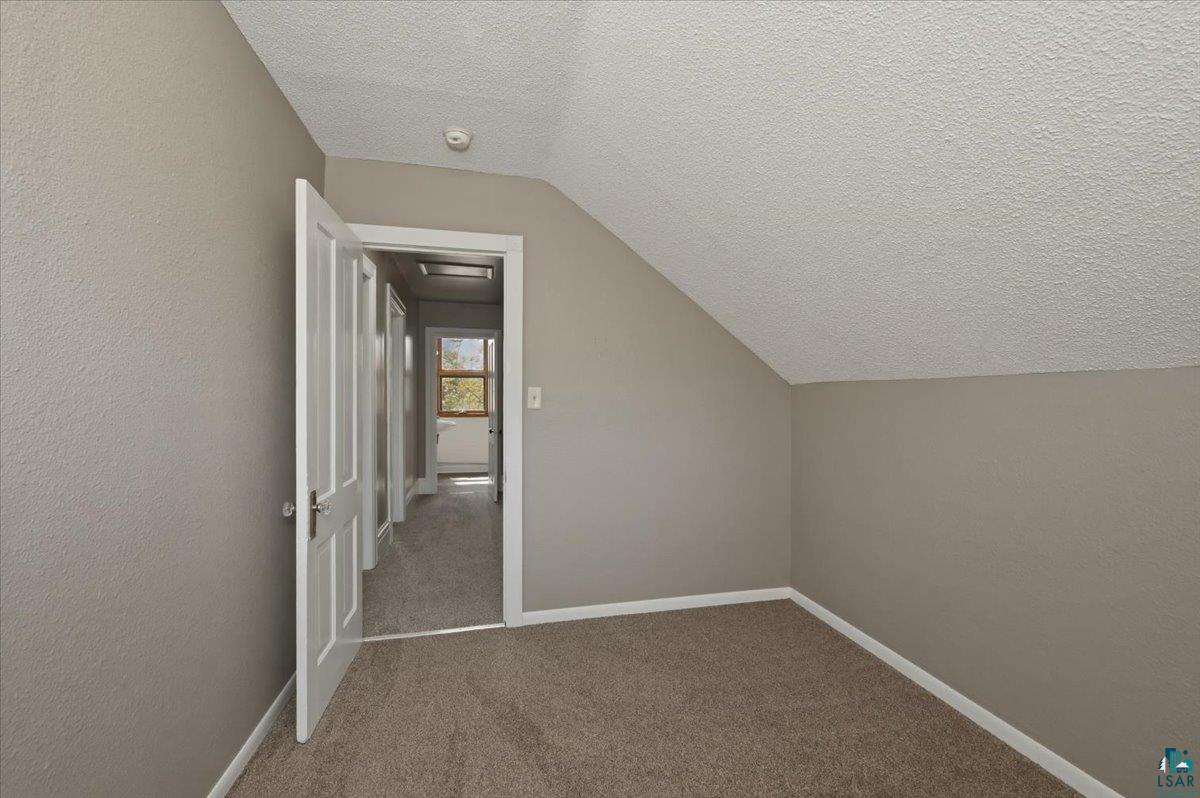 5319 East 3rd Street Superior, WI 54880 - Photo 25 of 33 Interior room with neutral gray wall paint, textured ceiling, and plush carpet flooring