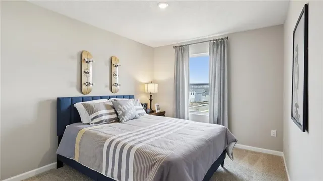 a bedroom with a large bed and a large window