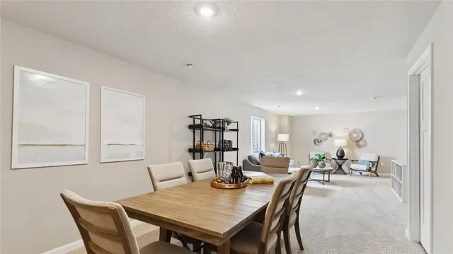 a view of a house with a yard and a large tree center