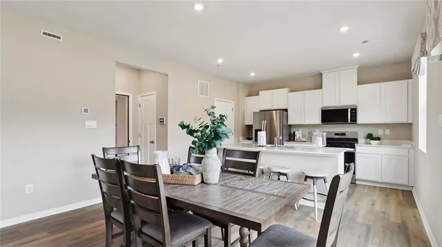 a view of a dining room with furniture and wooden floor