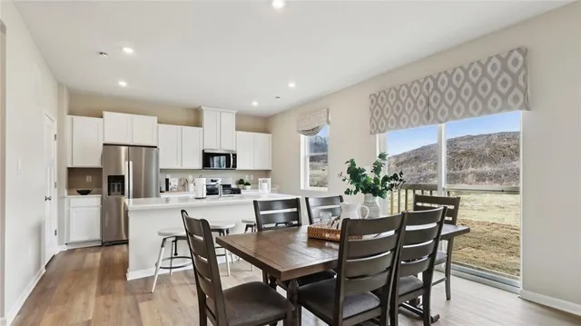 a view of a dining room with furniture window and wooden floor