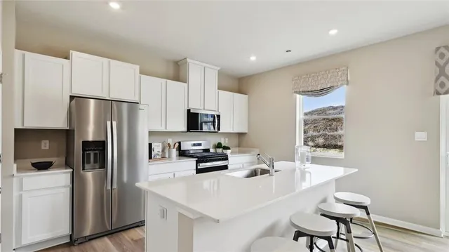 a view of a workspace with furniture and a bookshelf