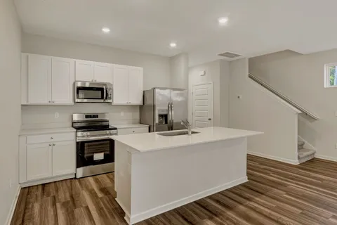 a view of kitchen with sink microwave and stove