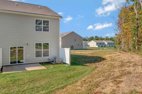 an empty room with closet and a ceiling fan