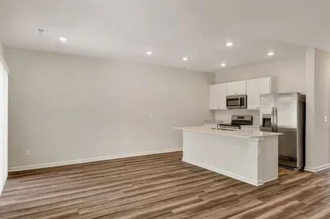 a kitchen with stainless steel appliances a refrigerator and a stove top oven