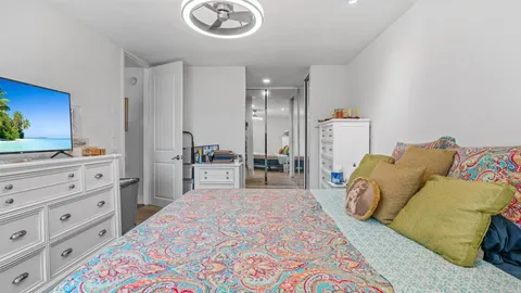 a spacious bedroom with a bed and a cabinets