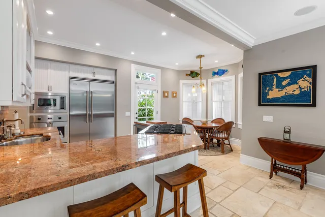 a large kitchen with granite countertop a stove and a sink