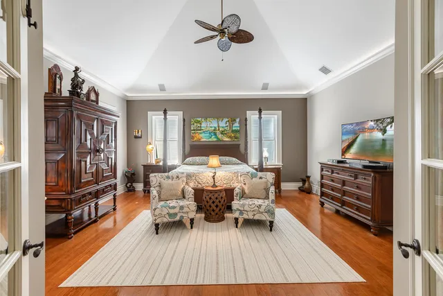 a bedroom with a bed and a chandelier