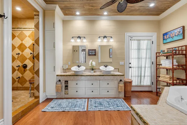 a spacious bathroom with a tub double vanity and a sink