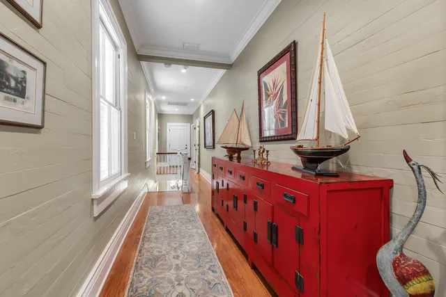 a view of a hallway with wooden floor and stairs