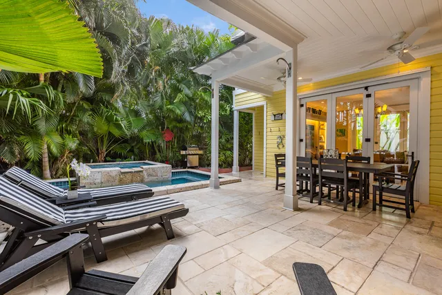 a view of a house with a patio and a yard