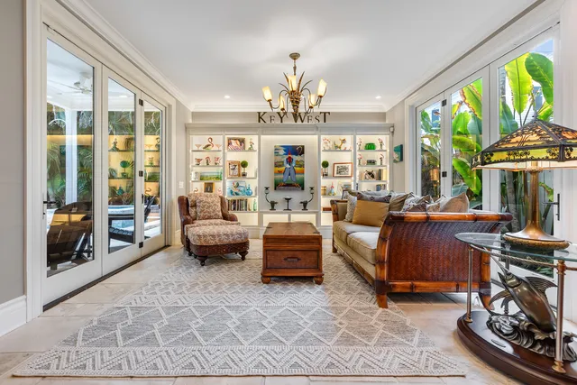 a living room with furniture and a chandelier