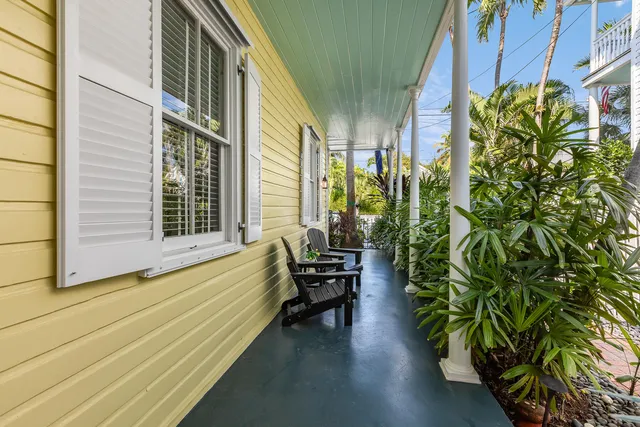 a view of a chair and table in the backyard of the house