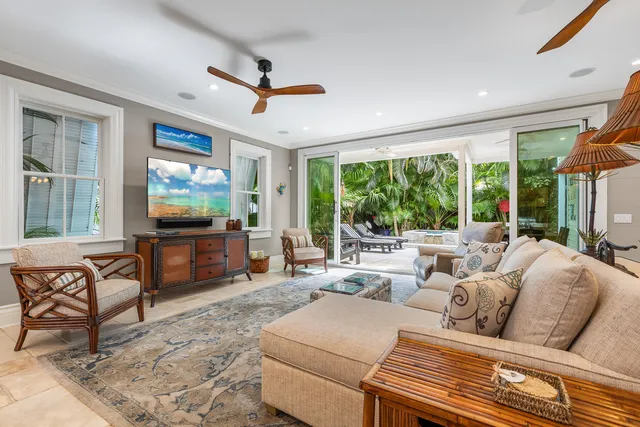 a living room with furniture a large window and a flat screen tv