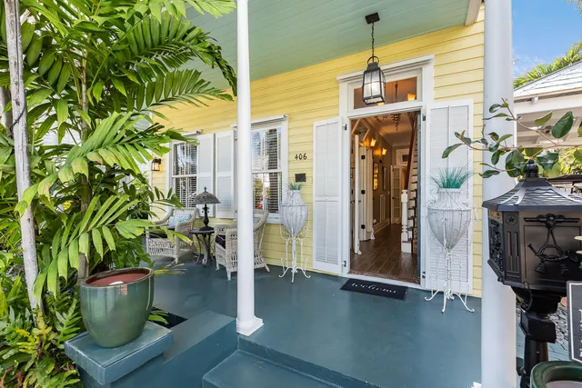 a front view of a house with outdoor seating