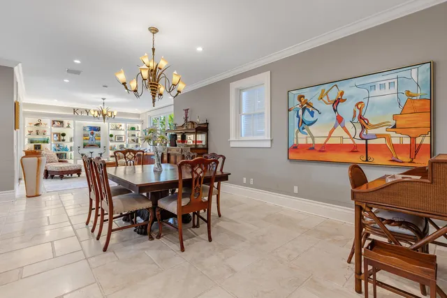 a view of a dining room with furniture and chandelier