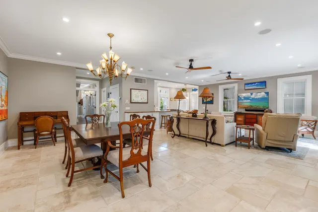 a living room with lots of furniture and a chandelier