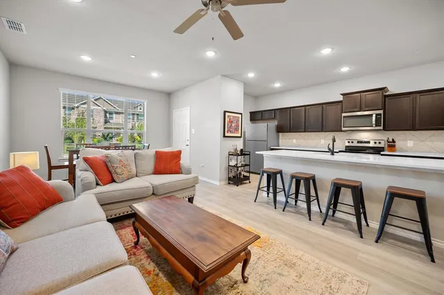 a living room kitchen with a table and chairs