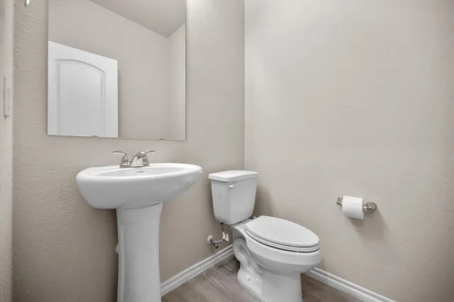 a bathroom with a sink a toilet and mirror