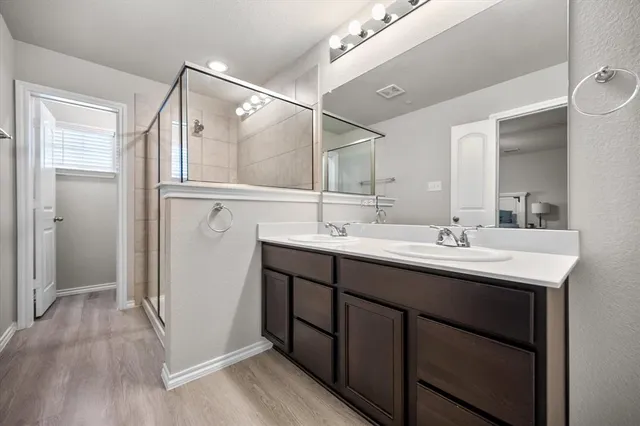 a bathroom with a double vanity sink and mirror