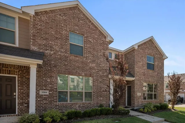 a view of a brick house with many windows