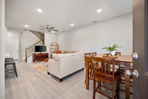 a living room with furniture and a dining table