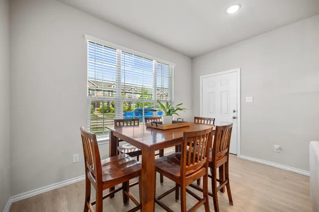 a view of a dining room with furniture and a potted plant