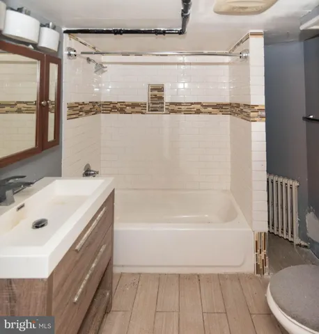 a bathroom with a tub a sink and a shower