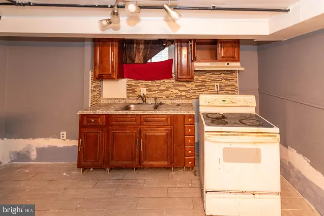 a kitchen with a stove a sink and a microwave