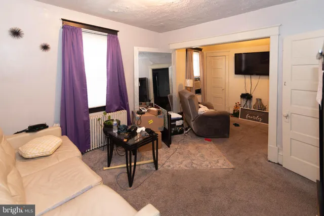 a bedroom with furniture and a flat screen tv