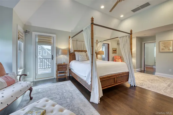 a bedroom with a bed next to a window and a flat screen tv