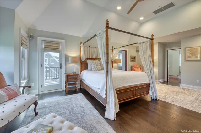 a bedroom with a bed next to a window and a flat screen tv