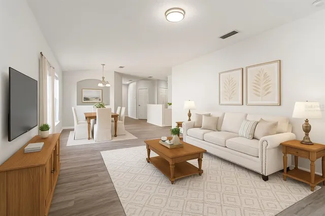 a view of a house with backyard garden and tree