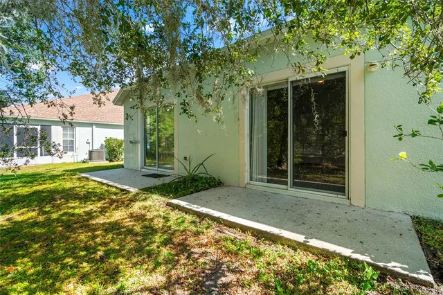 an aerial view of a wooden house with a yard