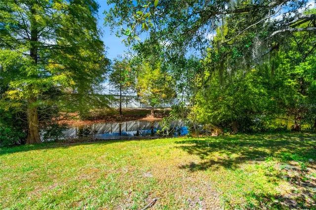 an aerial view of residential houses with outdoor space and swimming pool