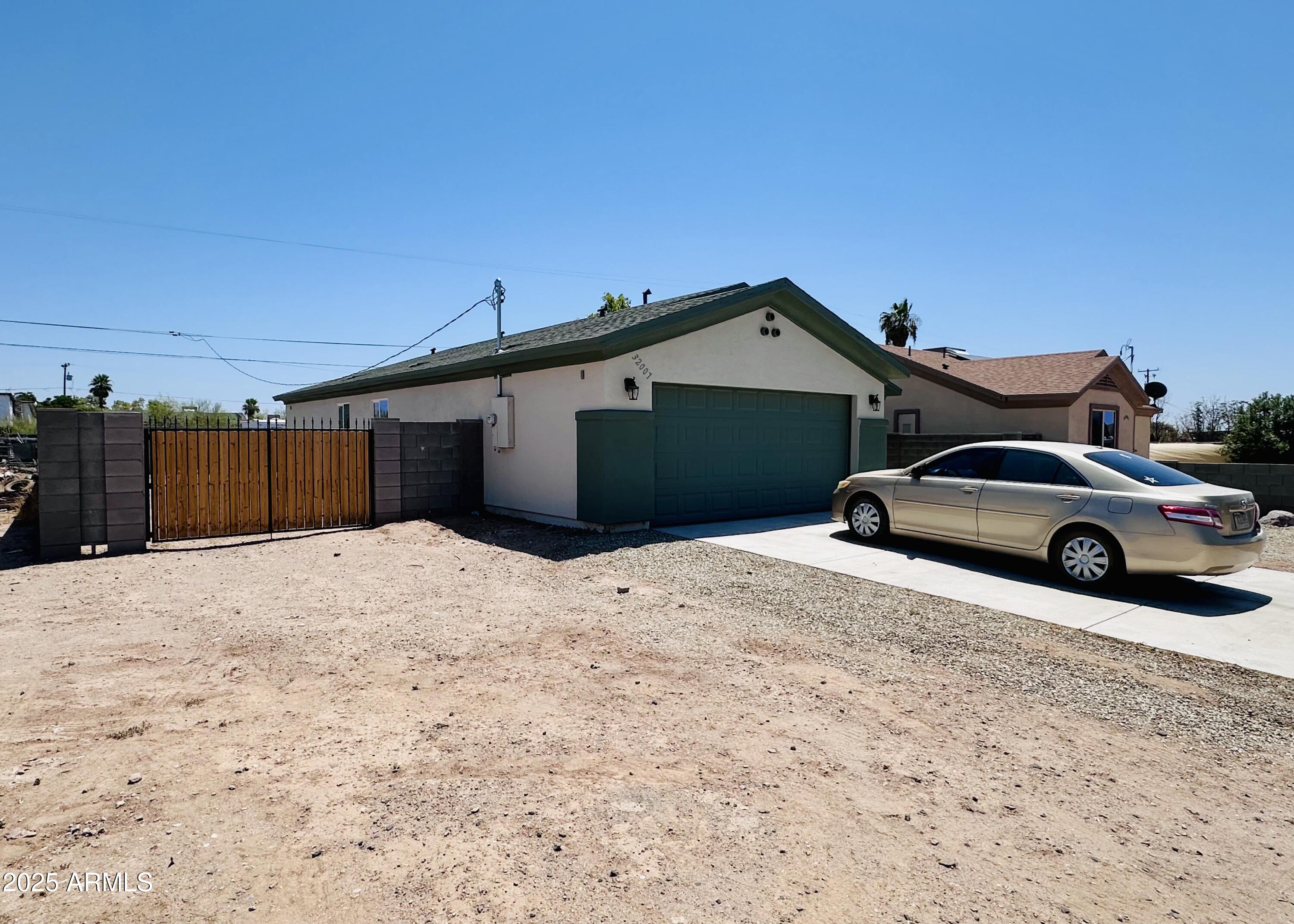 32007 North Bush Street Wittmann, AZ 85361 - Photo 2 of 22 a car parked in front of a house