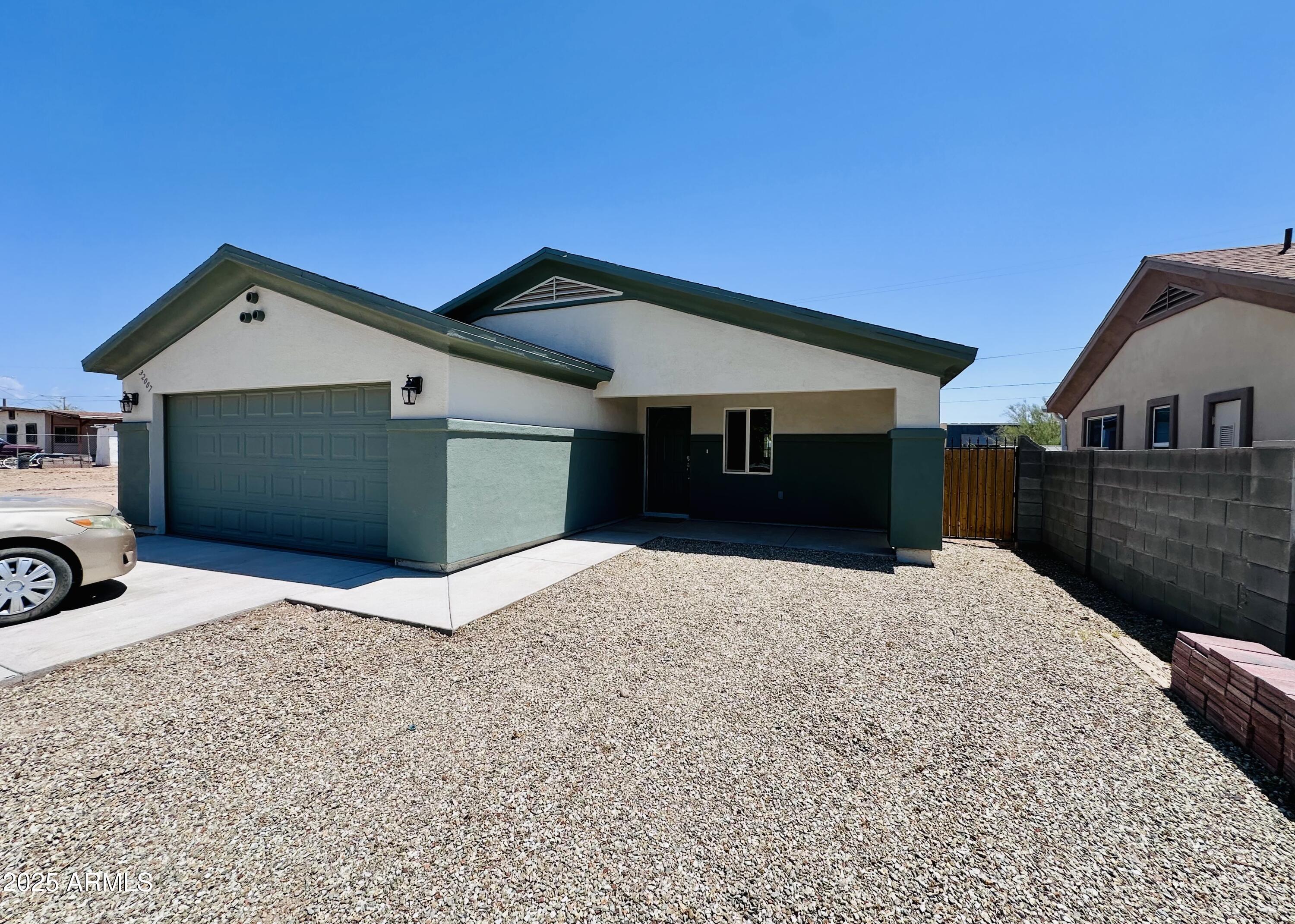 32007 North Bush Street Wittmann, AZ 85361 - Photo 3 of 22 a front view of a house with a yard and garage