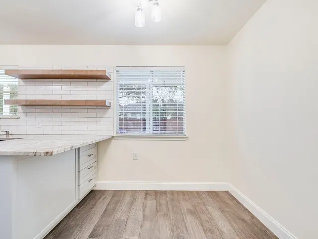a view of storage and utility room with wooden floor