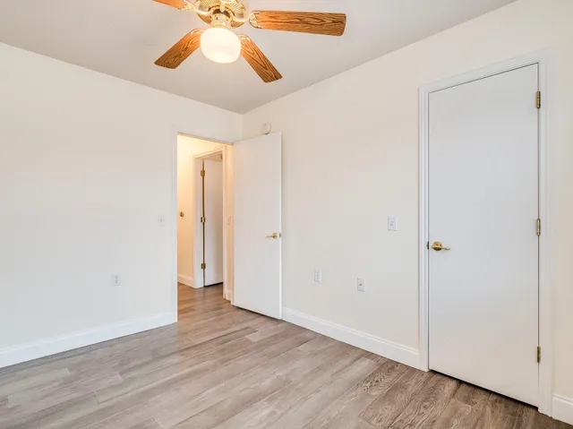 a view of an empty room and wooden floor