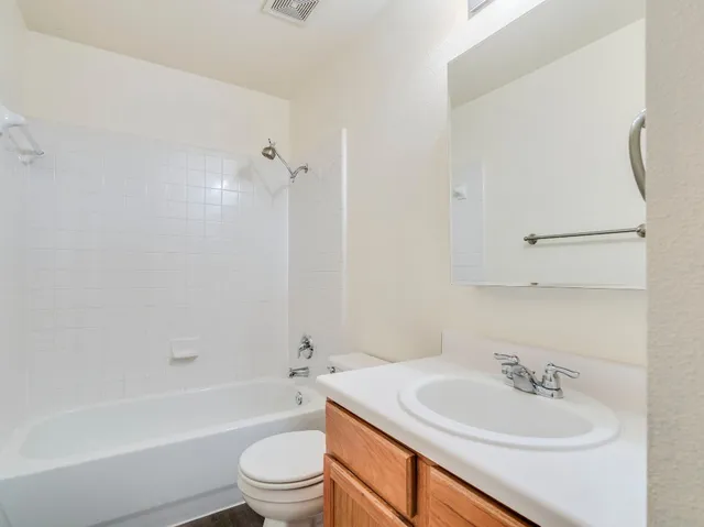 a bathroom with a sink a toilet and a bathtub