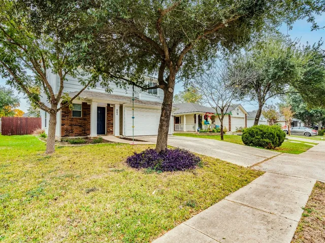 a front view of a house with garden