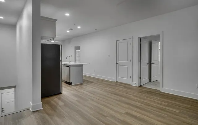 an empty room with wooden floor and closet