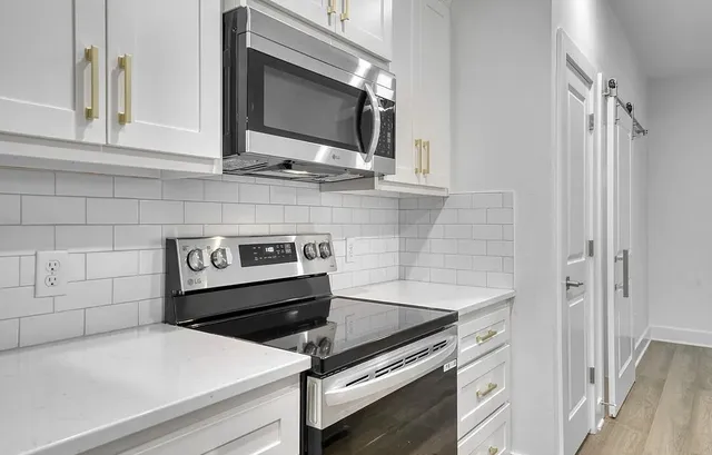 a kitchen with a stove and a microwave