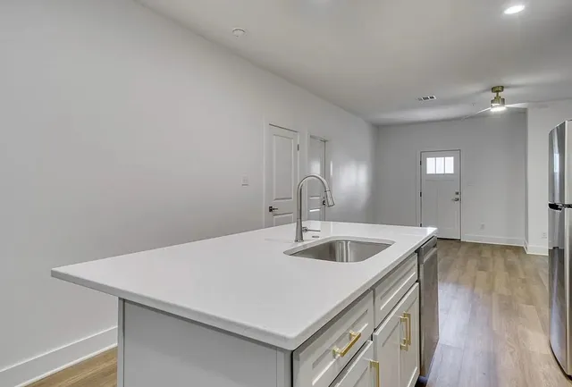 a kitchen with a sink and cabinets